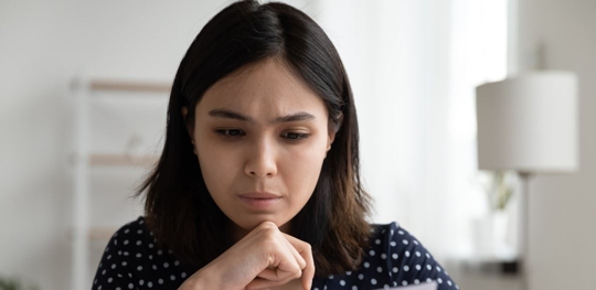 sad woman looking at paperwork