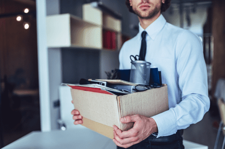 person carrying box from desk