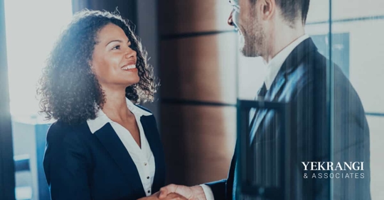two workers shaking hands