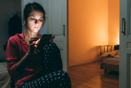 woman looking on phone at night
