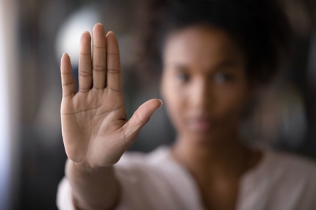 Crop close up focus of African American woman show palm hand against violence toward women
