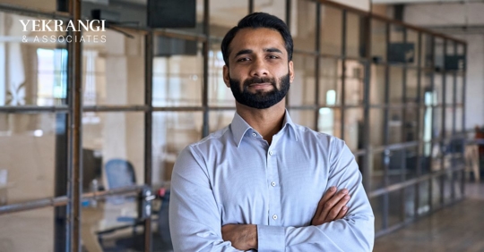 Hispanic business owner with arms crossed