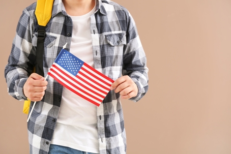 person with backpack and American flag