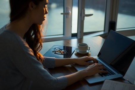 woman working from home on laptop computer